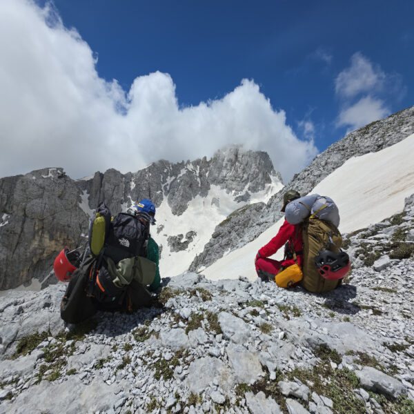 Two hikers resting during the Jezerca peak climb, Albanian Alps
