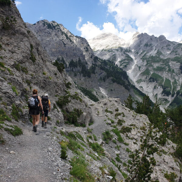 hikers on balkan trail going downhill in the best vally in Albania valbona valley
